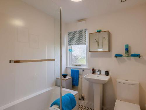 a bathroom with a toilet and a sink and a shower at 1 Bed in Whitegate 91266 in Whitegate
