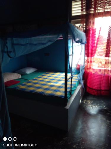 a bunk bed with a checkered mattress in a room at Muru's Place in Dickwella