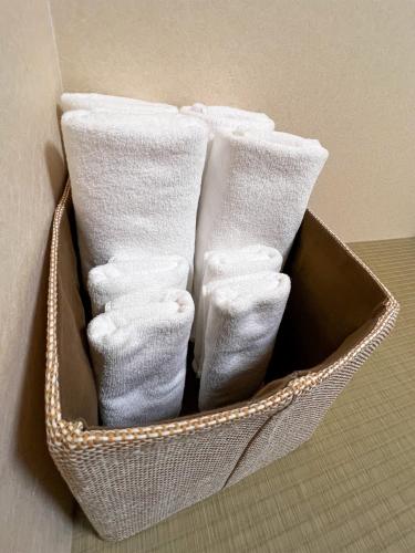 a basket filled with white socks sitting on a floor at Hondori Inn in Hiroshima