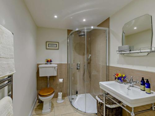 a bathroom with a shower and a toilet and a sink at 1 Bed in Hawick 91437 in Denholm