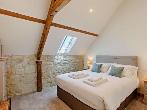 a bedroom with a large bed in a attic at 4 Bed in Melbury Abbas 91456 in Melbury Abbas