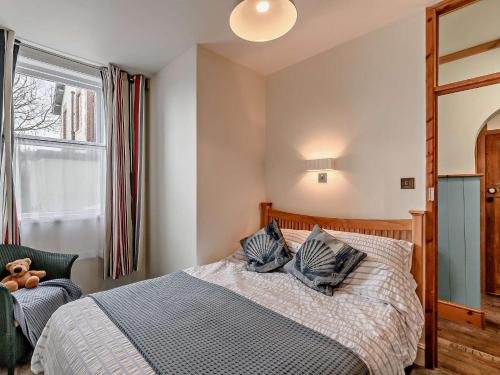 a bedroom with a bed with two pillows on it at 2 Bed in Boulmer 91486 in Boulmer