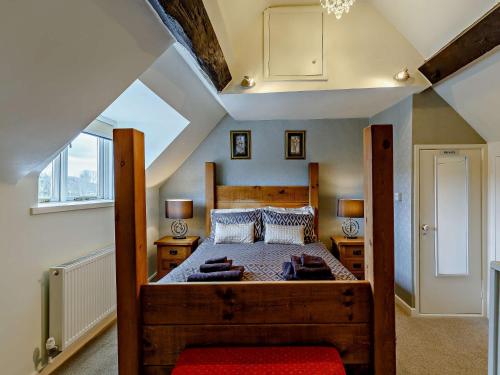 a bedroom with a large wooden bed in a attic at 2 Bed in Bridgnorth 91551 in Bridgnorth