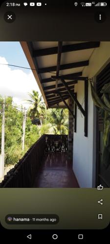 a view of a balcony of a house with a roof at Muru's Place in Dickwella