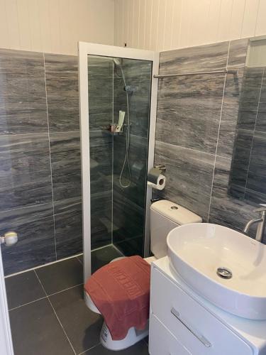 a bathroom with a shower and a toilet and a sink at The Pubpa Backyard in Ban Nam Rap