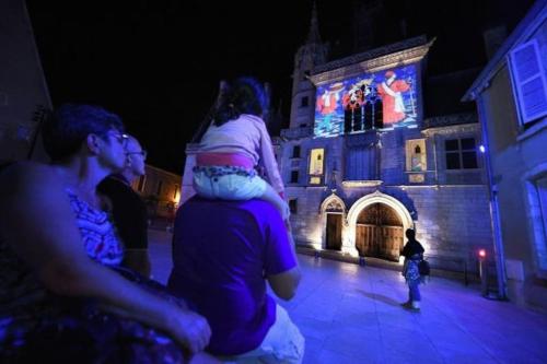 a group of people sitting in front of a building at Le Baldaquin quartier cathédrale-marais in Bourges