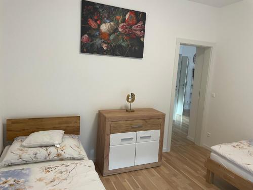 a bedroom with two beds and a painting on the wall at Sorinas Home WB7 Top6 in Wagersbach
