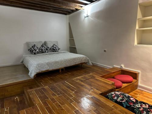 a room with a bed in a room with wooden floors at Loft sur Notre-Dame/Saint-Michel in Paris