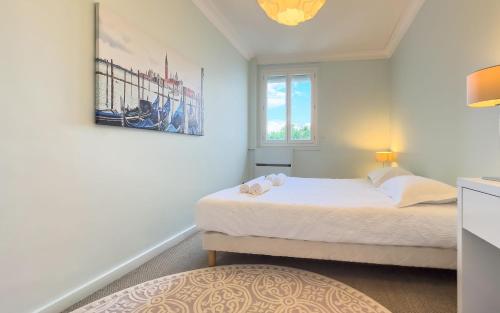a bedroom with a bed and a picture on the wall at Le Trendy by Winsome Destination in Cannes
