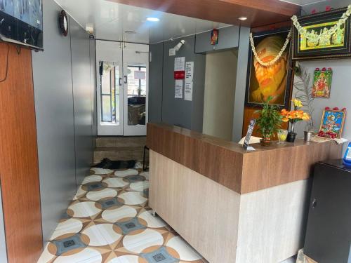a restaurant counter with a dog laying on the floor at HOTEL MOUNTAIN PARADISE in Bangalore