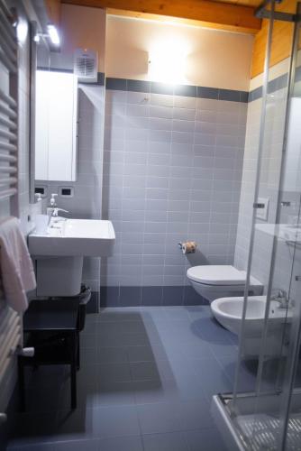 a bathroom with a sink and a toilet at Pietra di Verona Residenza in Verona