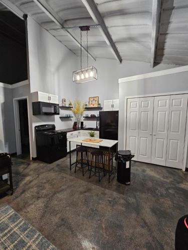 a large kitchen with a table and a white door at Canadian river villas Amarillo in Amarillo