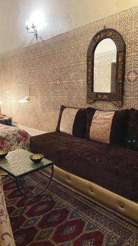 a bedroom with a bed and a mirror on the wall at DAR LALLA Aicha 2 in Rabat
