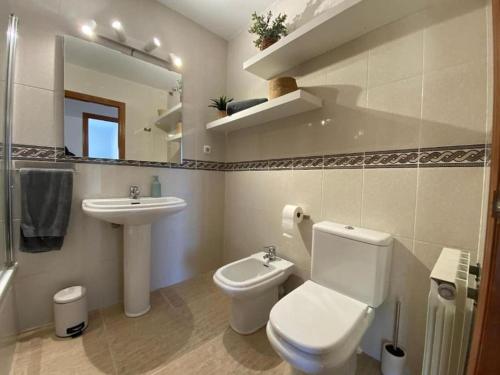 a bathroom with a white toilet and a sink at Salou. Sol, playa y relax. in Salou