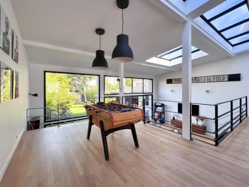 a large living room with a pool table in the middle at Magnifique maison familiale - Idéalement située pour les JO 2024 in Colombes