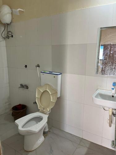 a bathroom with a toilet and a sink at Gauri Villa in Dwarka