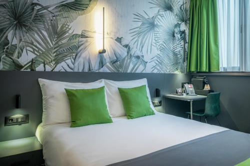 a bedroom with a bed with green and white pillows at City Joy - sports Center Tasmajdan in Belgrade