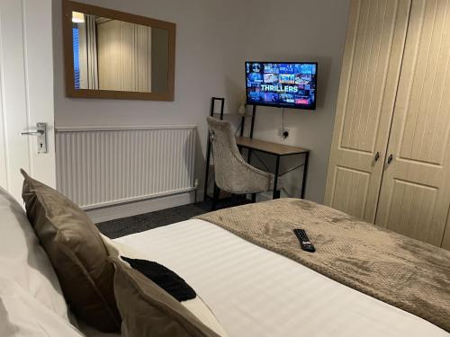 a hotel room with a bed and a television at Village Lodge in Middlesbrough