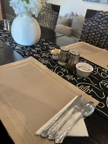 a table with silver utensils on top of a table at Black Diamond B&B Guesthouse in Upington