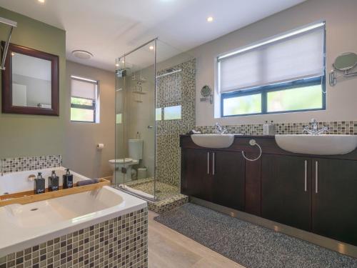 a bathroom with a tub and a sink and a shower at Sanddrif Guest Farm in Stellenbosch