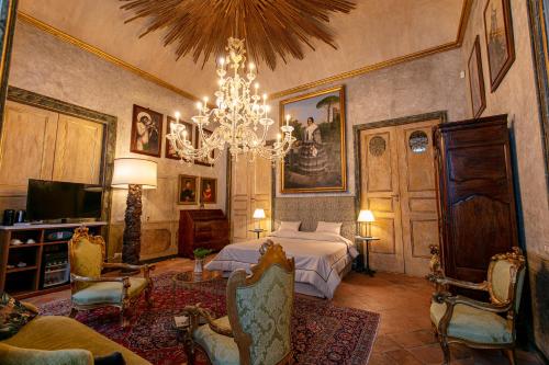 a bedroom with a bed and a chandelier at Palazzo Doria Napoli in Naples