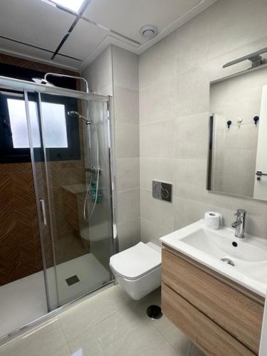 a bathroom with a shower and a toilet and a sink at Prestige Sunny Terrace Apartment - Torrevieja in Torrevieja