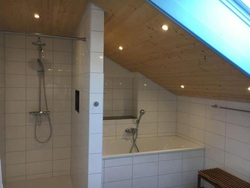 a bathroom with a shower and a bath tub at Villa Kleine Welle in Trent
