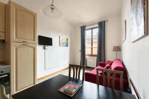 a living room with a red couch and a table at Era Rental Apartments in Florence