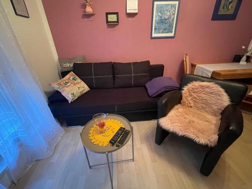 a living room with a couch and a table at Pension Doreen Nieswand in Gamstädt