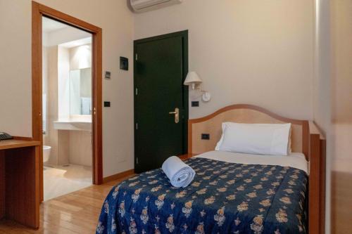 a bedroom with a bed and a green door at Hotel Bologna in Turin
