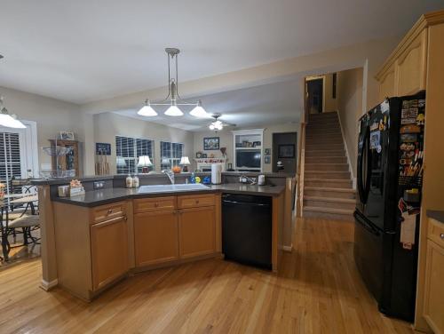 a kitchen with a sink and a refrigerator at Chateau Relaxo Concord in Huntersville