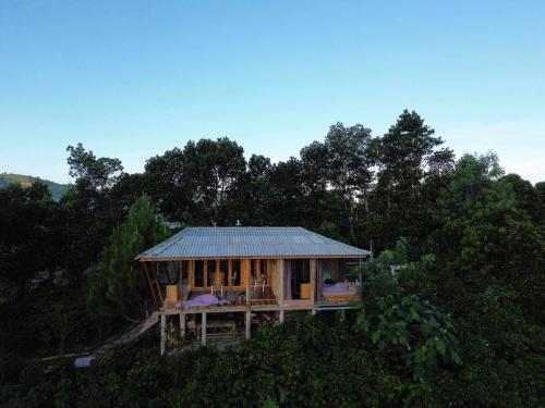 a house on top of a hill with trees at Năm mùa Bungalows in Hương Hóa