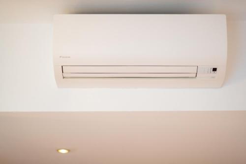 a television hanging from a ceiling in a room at Hotel Romantic in Cavaion Veronese
