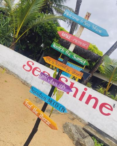 a sign post with many different street signs at Sea Shine Guest House in Hikkaduwa