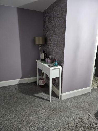 a white table with a lamp on it in a room at Bolton arms downholme in Richmond