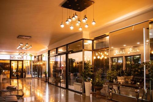 a shopping mall with a lot of windows at Hotel Zhibek Zholy in Shymkent