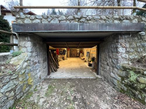 an entrance to a building with a stone wall at Chalet Corona in Giustino