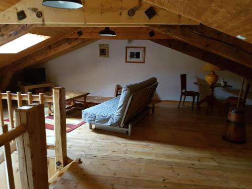 a living room with a couch in a attic at " gite Au Pied Du Chapelas" in Le Plagnal
