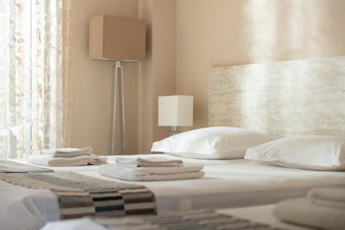- une chambre avec un lit et des serviettes dans l'établissement Sithonia Suites Luxury Apartments, à Nikiti