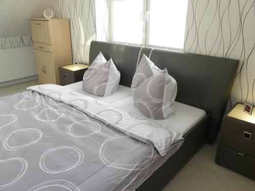 łóżko z 3 poduszkami w pokoju w obiekcie Fewo direkt am See w mieście Dabel