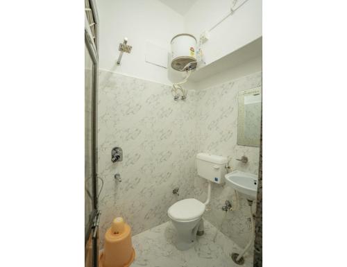 a bathroom with a toilet and a sink at Hotel Chouhan Palace, Jaisalmer, RJ in Jaisalmer