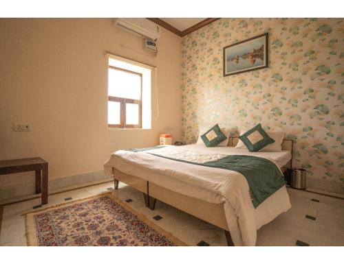 a bedroom with a bed and a window in it at Hotel Chouhan Palace, Jaisalmer, RJ in Jaisalmer