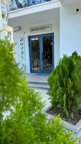 a entrance to a building with a blue door at Mykonos Hotel Apart - Maestro in Odesa