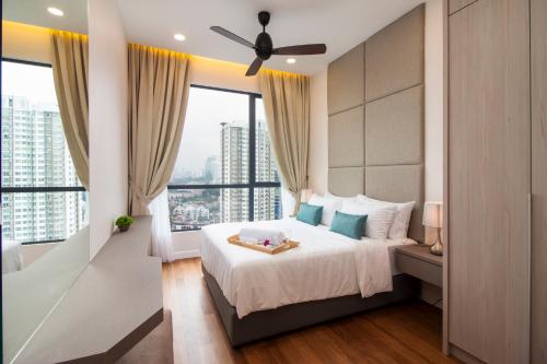 a bedroom with a bed and a large window at Nadi Bangsar by Plush in Kuala Lumpur