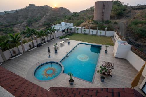 an overhead view of a swimming pool on a house at The Gaj Kesri Gir - Best Wildlife Resort in Gir in Dudhāla