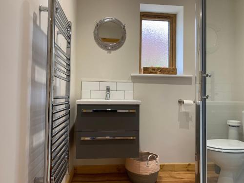 a bathroom with a sink and a toilet at The Piggery at the Cottage in Wool