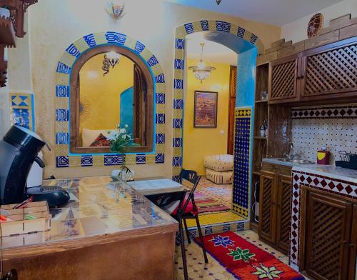 a kitchen with a counter and a mirror in a room at Dar Sandra Moroccan Tiny House in Tangier