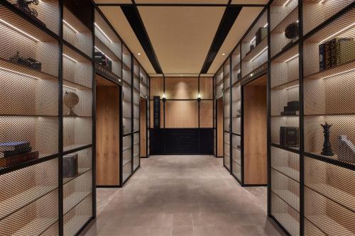 a hallway with wooden walls and a door with glass panels at Four Points by Sheraton Nantong, Haimen in Nantong