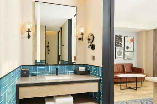 a bathroom with a sink and a mirror at Four Points by Sheraton Nantong, Haimen in Nantong