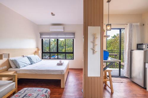 a small bedroom with a bed and a window at La salle Avenue Condo Residences in Bacolod